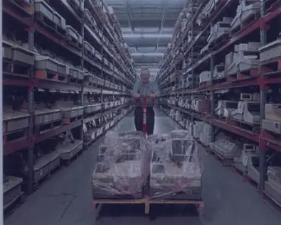 IW technologies warehouse employee pushing pallet