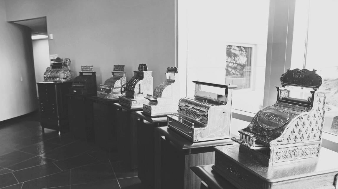 Black and white image of vintage cash registers at IW technologies